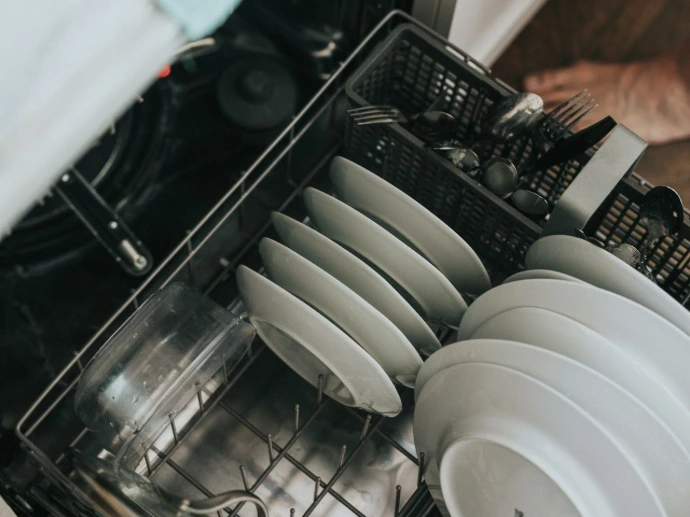 white ceramic plate on black dishwasher